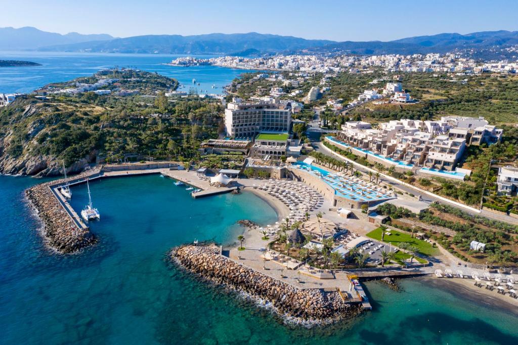 an aerial view of a resort with a harbor at Wyndham Grand Crete Mirabello Bay in Agios Nikolaos