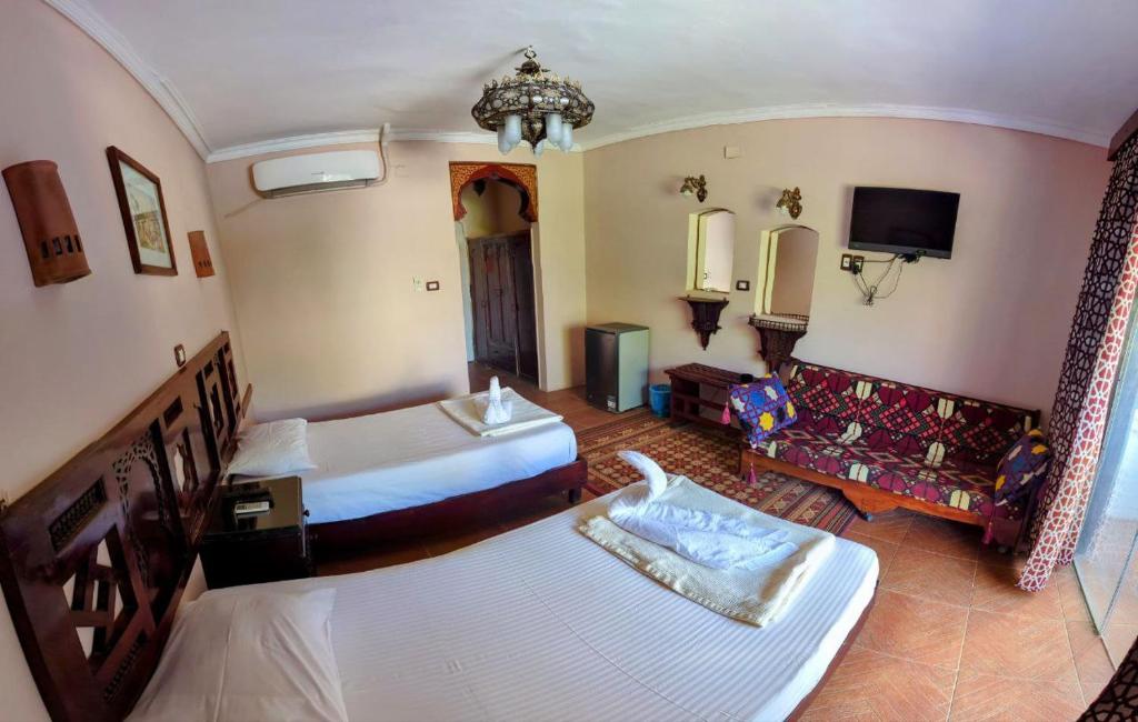 Postel nebo postele na pokoji v ubytování Ali Baba Hotel