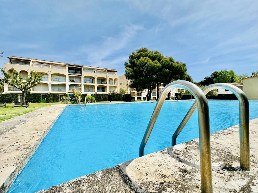 a swimming pool in front of a building at Mimoses CostaBravaSi in Sant Feliu de Guíxols