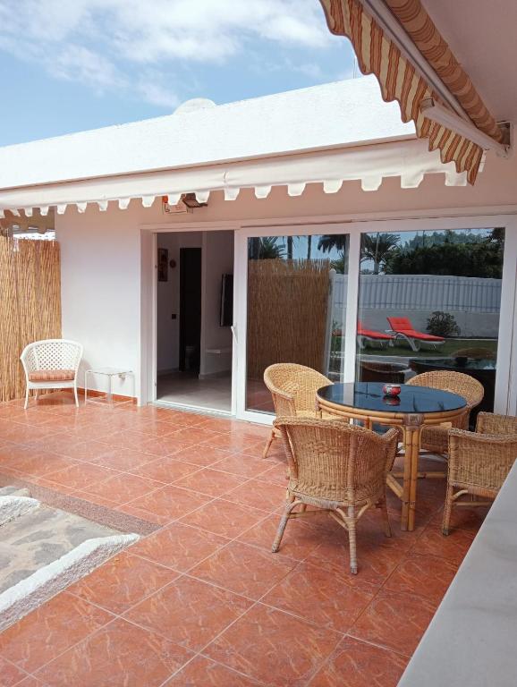 a patio with a table and chairs on a patio at Granada playa! in Maspalomas
