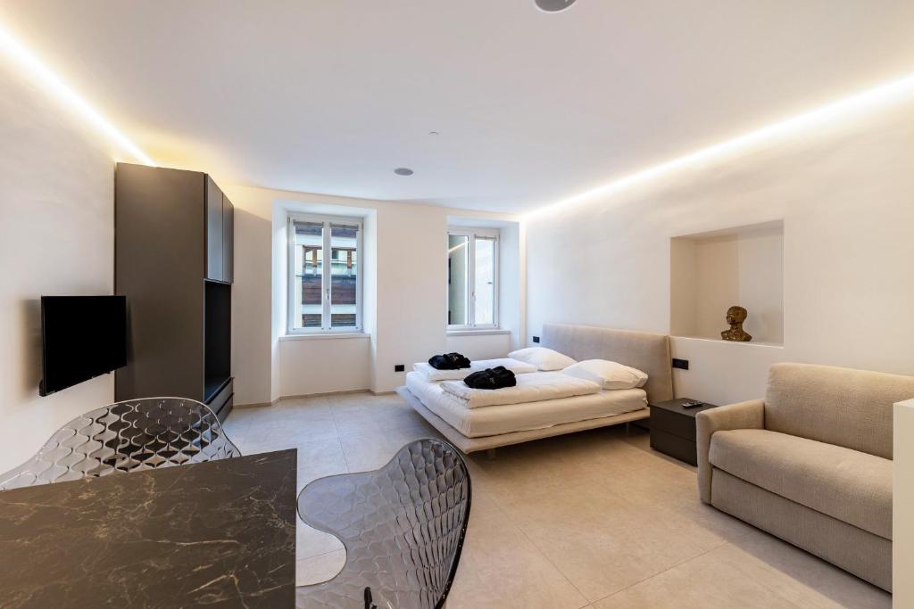 a living room with a bed and a couch at App 203 Palazzo Cavour in Bolzano