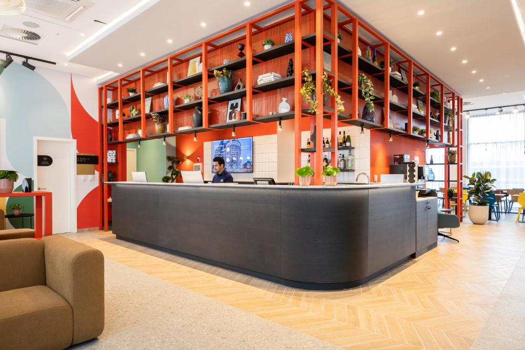 a lobby with a reception desk in a building at B&B HOTEL Mechelen in Mechelen