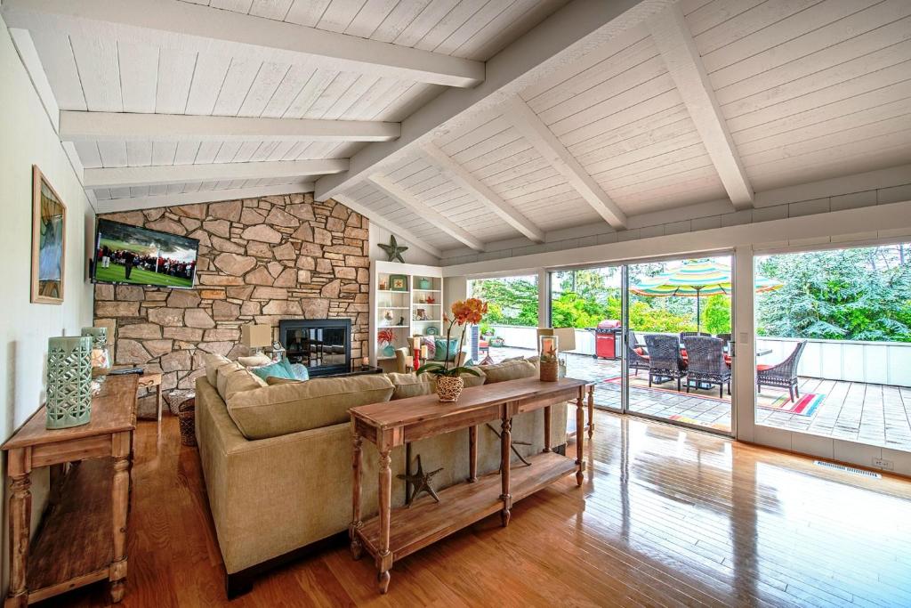 a living room with a couch and a stone wall at 3631 Casa Familia home in Pebble Beach