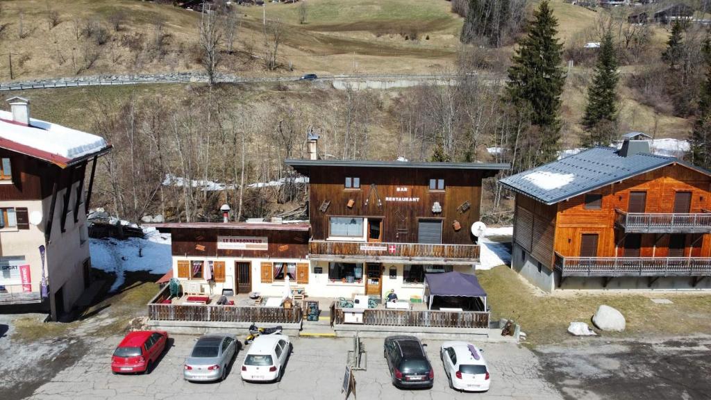 an aerial view of a house with cars parked in a parking lot at Le Randonneur in Flumet