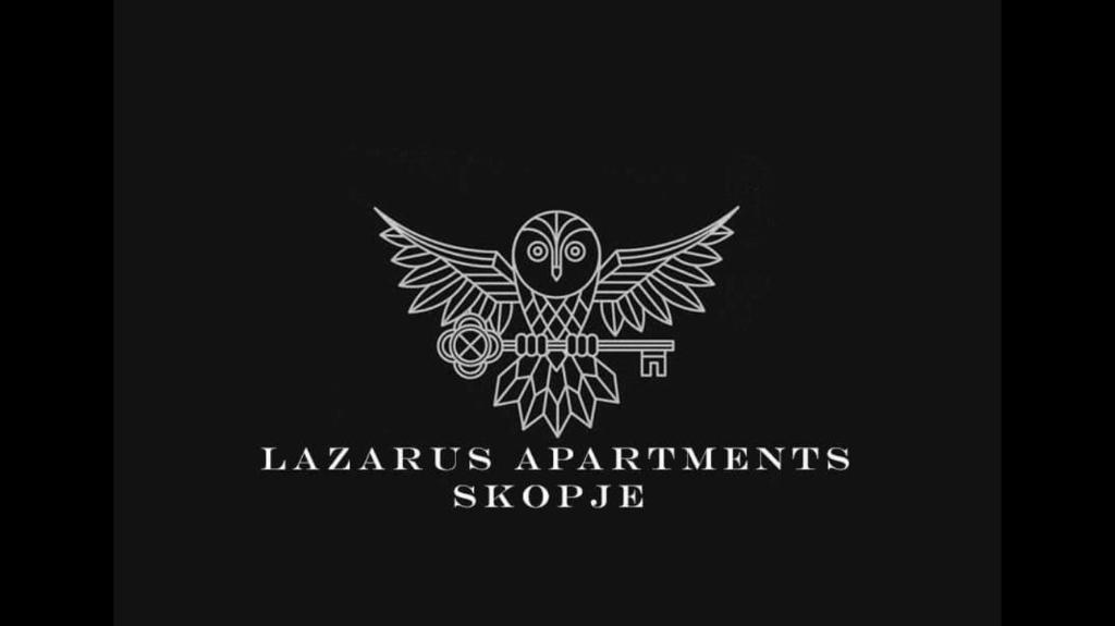 an owl is sitting on a stick in a logo at Lazarus Apartment in Skopje