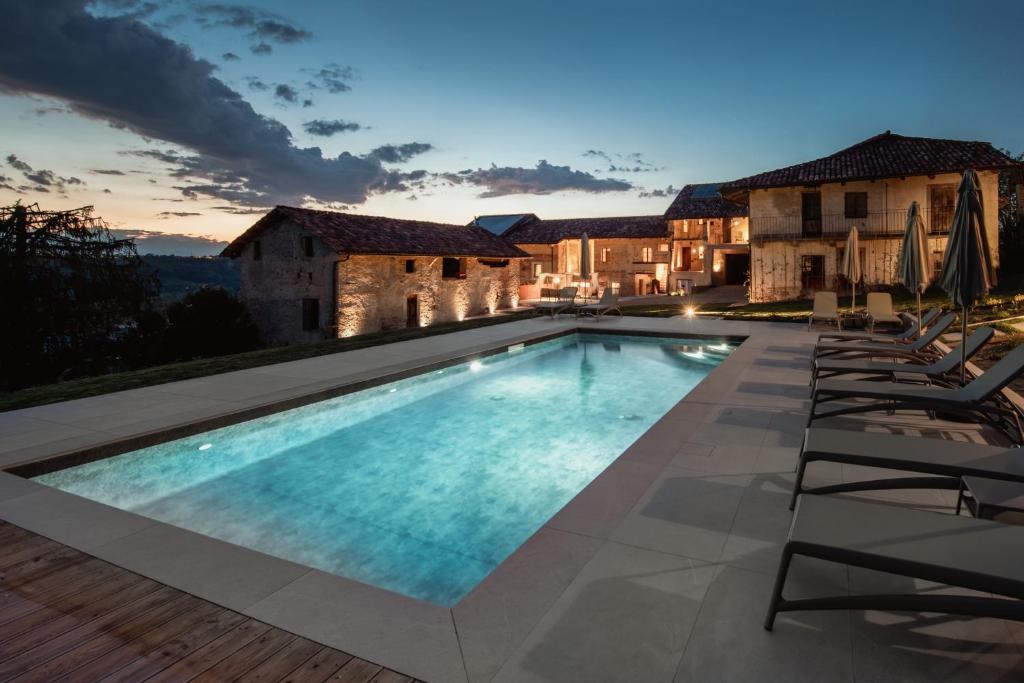a swimming pool in front of a villa at Relais Chiarene in Novello