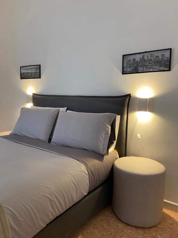 a bedroom with a bed with a table and lights at Casa Panorama, casa vacanza. in Torre del Greco