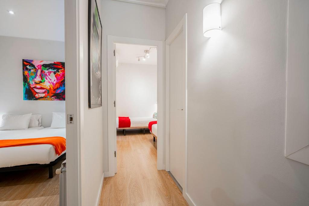 a bedroom with a bed and a painting on the wall at Barcelona Eixample in Barcelona