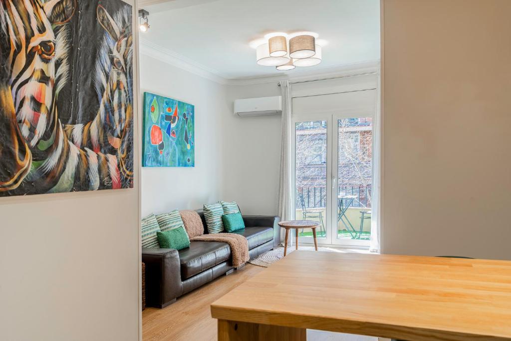 a living room with a couch and a table at Barcelona Eixample in Barcelona