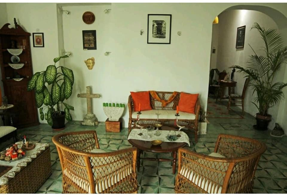 a living room with a couch and two chairs at House at Centro Histórico with pool in Mérida
