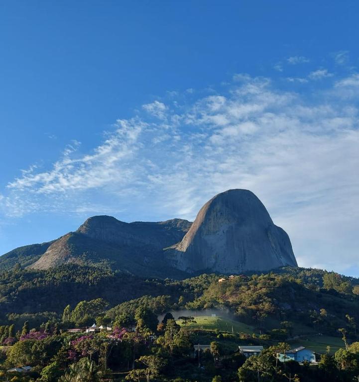 a view of a mountain with trees and a lake at Casa em Pedra Azul in Domingos Martins