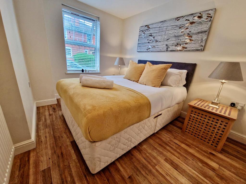 a bedroom with a large bed and a window at Stunning Luxury Serviced Apartment next to City Centre with Free Parking - Contractors & Relocators in Coventry