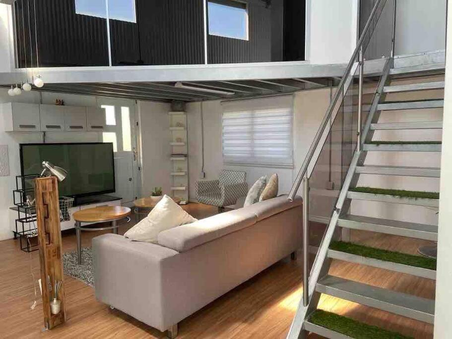 a living room with a loft bed and a couch at Centric Rustic Modern Downtown Executive Pad in Mayaguez