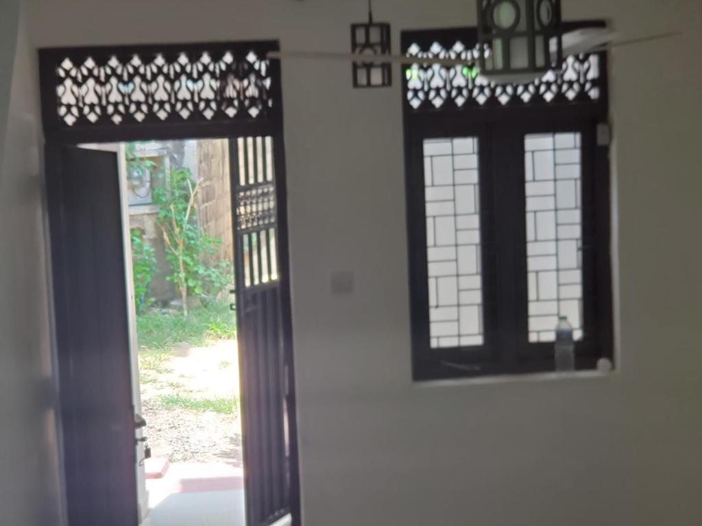 an open door of a house with a window at Mount lavinia home in Watumulla