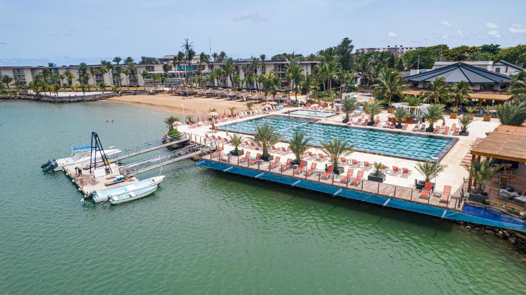 an aerial view of a resort with a boat in the water at Terrou-Bi in Dakar
