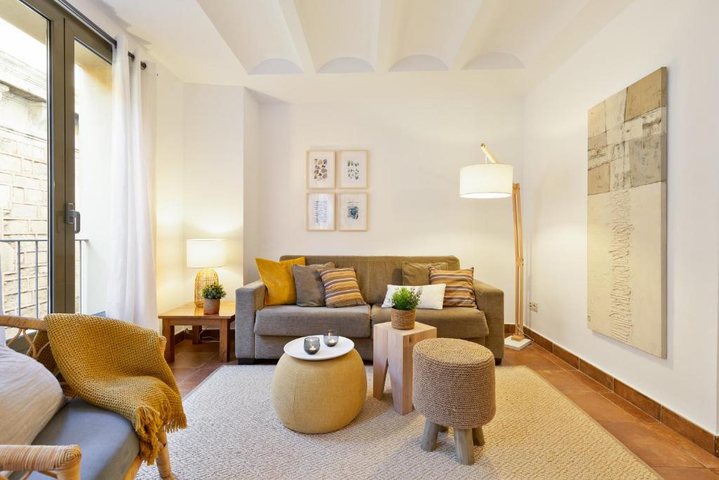 a living room with a couch and a table at Columbus Apartment in Barcelona