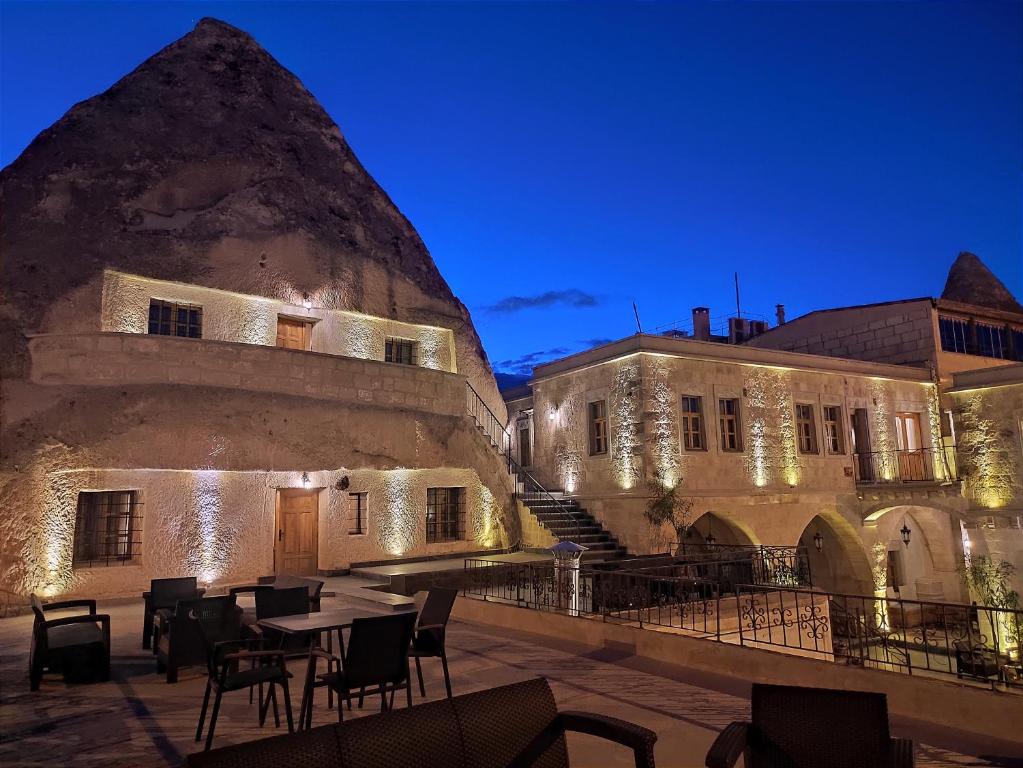 a courtyard of an old building with tables and chairs at Cave Hotel Saksagan in Göreme