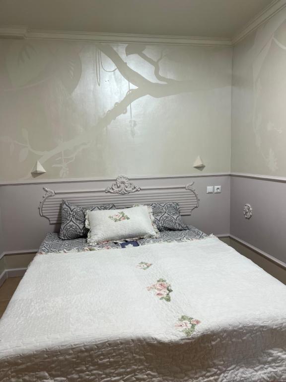 a bedroom with a large bed with a white blanket at Santa Marina Apartment 503 in Sozopol