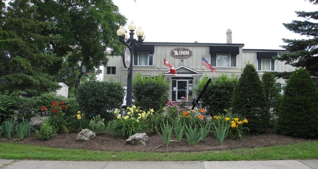 a garden in front of a house with flowers at The Inn At Lock Seven in Thorold