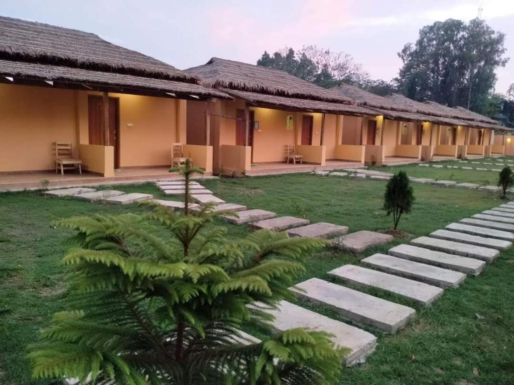 a resort with a pathway leading to a building at Angel Resort & Restaurant in Cox's Bazar