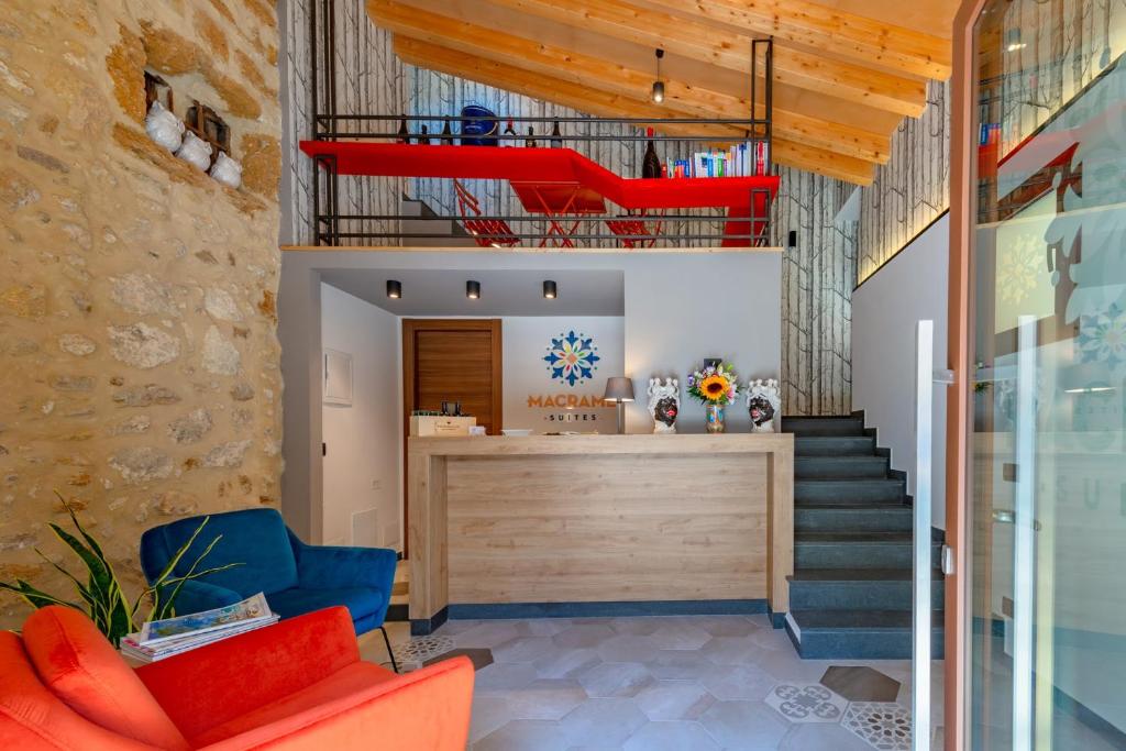 a living room with a red couch and a loft at Macramè Suites in Sciacca