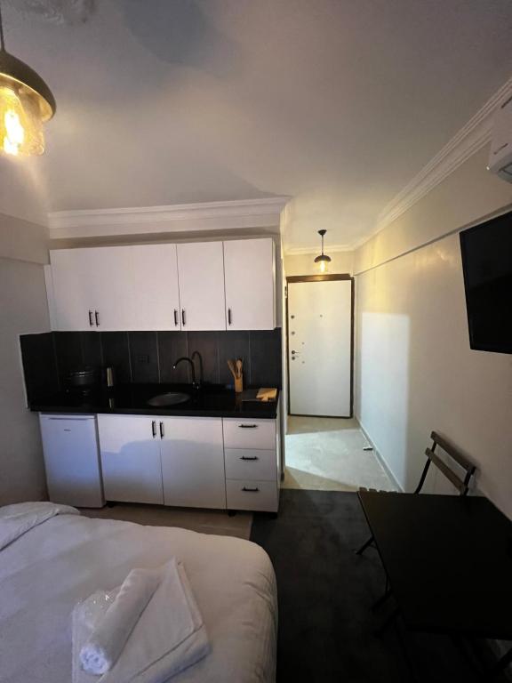 a bedroom with a bed and a kitchen with a sink at Mr Miller Suites in Istanbul