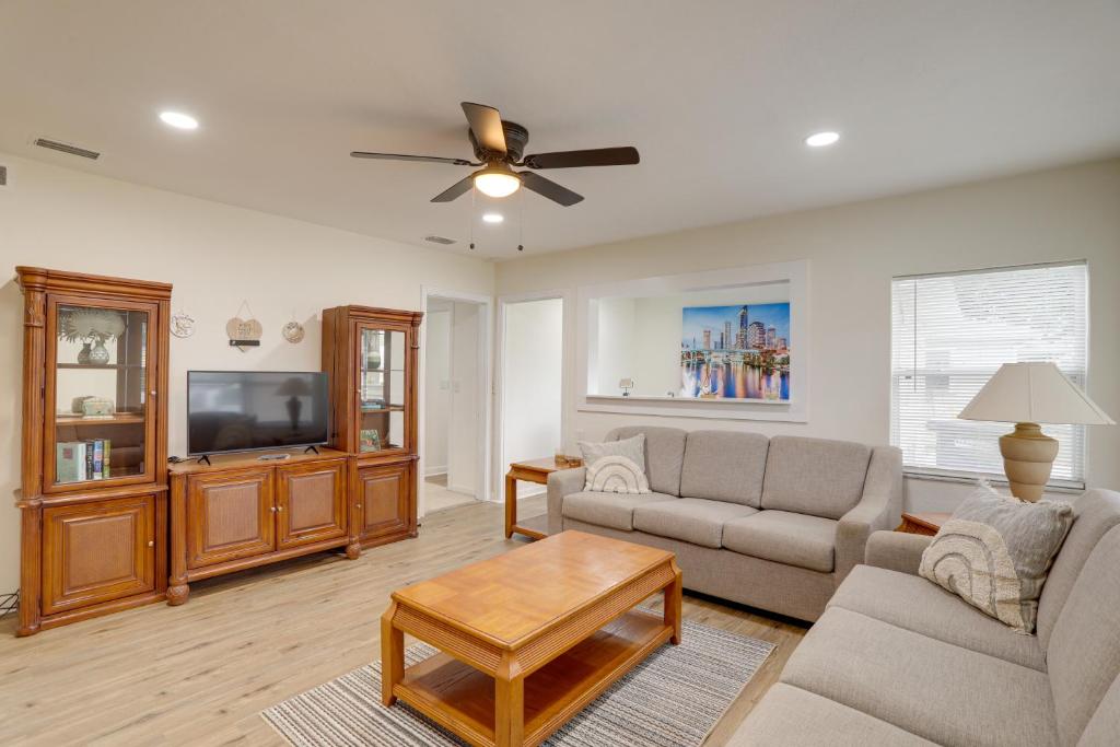 a living room with a couch and a tv at Clearwater Vacation Rental Near Downtown and Beaches in Clearwater