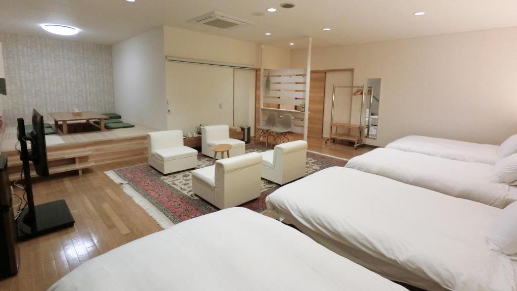 a bedroom with two beds and a living room at Yurihonjo - Hotel - Vacation STAY 42543v in Yurihonjo
