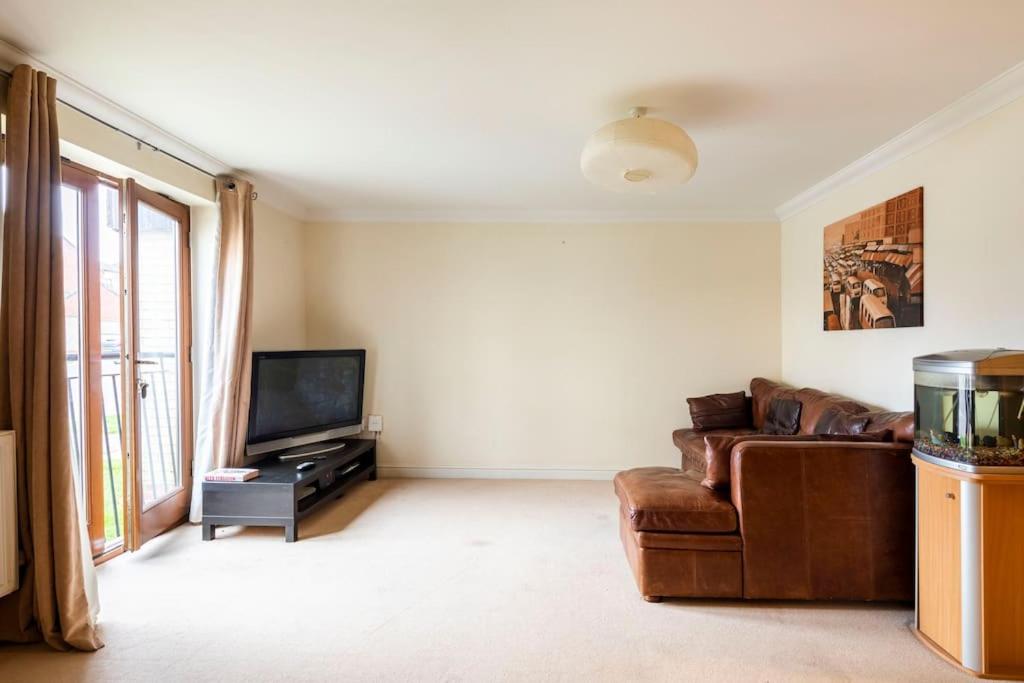 a living room with a couch and a television at 2 Beds Broughton Apartment in Broughton