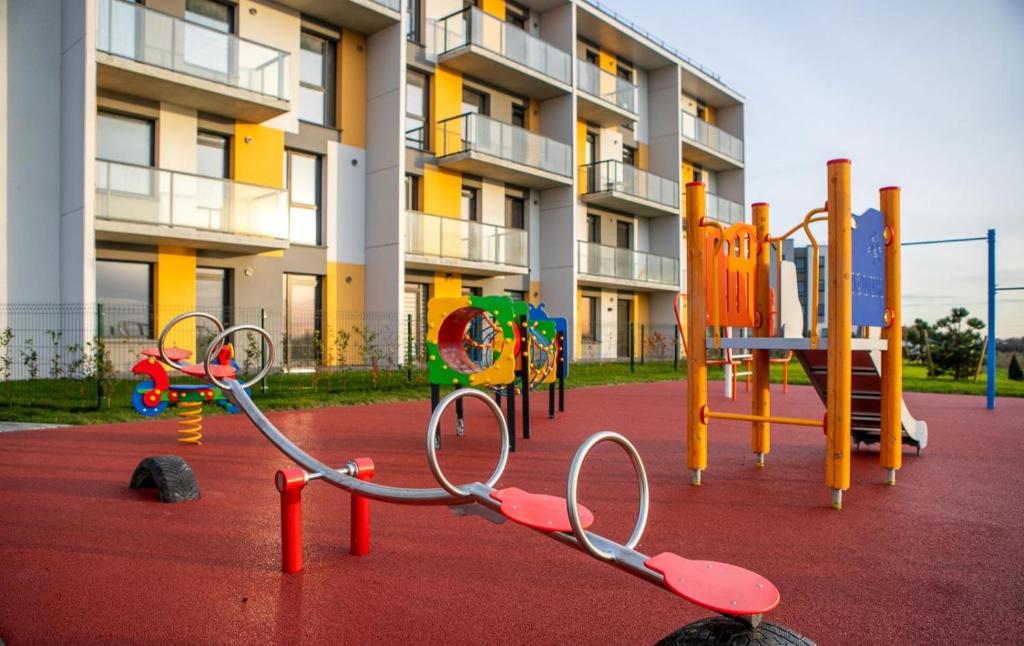 a playground in front of a apartment building with at Deluxe apartments - self check in in Klaipėda