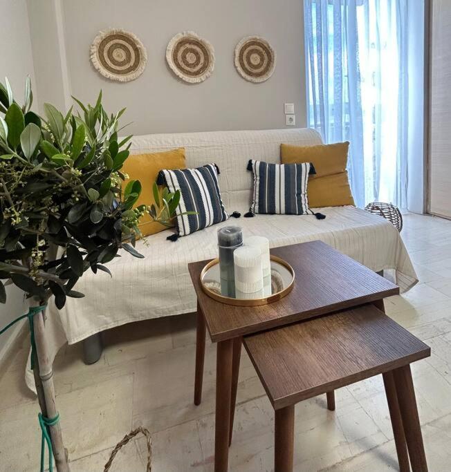 a living room with a couch and a table at Lemon Tree Suite in Kos Town