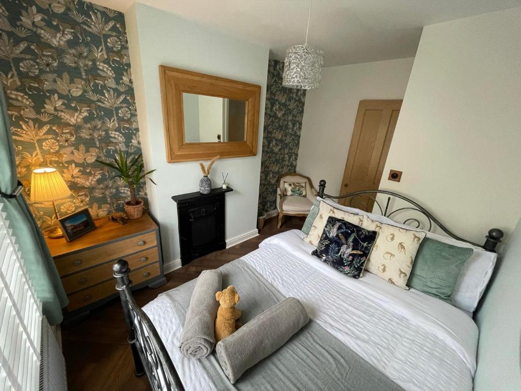a bedroom with a bed with a teddy bear on it at The Railway Cottage Bridgnorth in Bridgnorth
