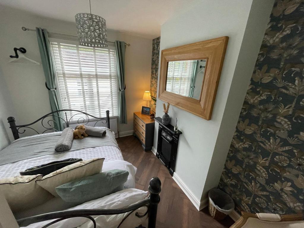 a bedroom with a bed with a dog laying on it at The Railway Cottage Bridgnorth in Bridgnorth