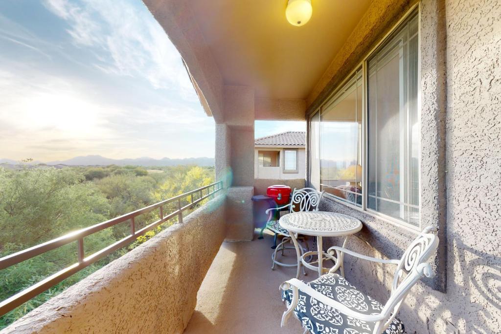 ein Balkon mit Tisch und Stühlen und Aussicht in der Unterkunft Vistoso Golf Casitas II #209 in Oro Valley