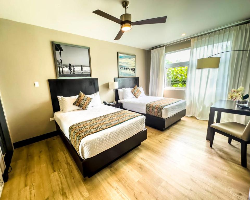 a bedroom with two beds and a ceiling fan at R Hotel Kingston in Kingston