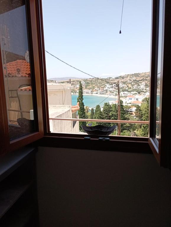 a window with a bowl on a window sill at Sofirene II in Batsi
