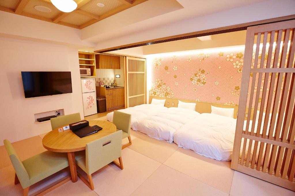 a bedroom with a bed and a table and a dining room at Hotel Sanriiott Kitahama - Vacation STAY 33509v in Osaka
