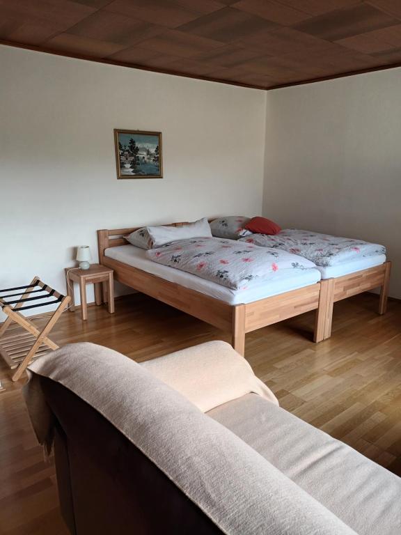 a bedroom with a bed and a couch in it at Büdingen-Ferienwohnung Bausch in Büdingen