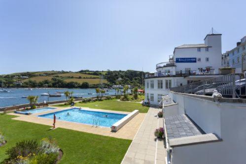 a view of a swimming pool next to a building at 28 The Salcombe in Salcombe