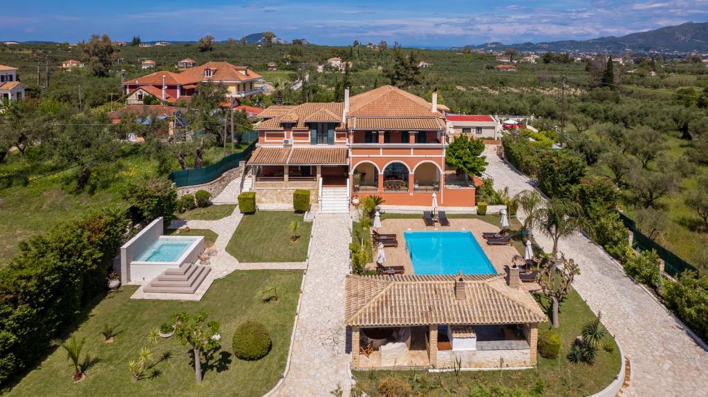 an aerial view of a house with a swimming pool at Amalthia Villa in Mouzákion