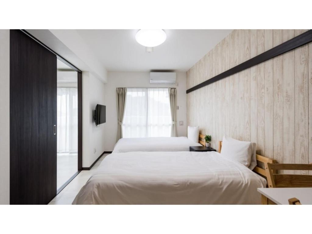 Kama o mga kama sa kuwarto sa Hotel Thomas Nago - Vacation STAY 40482v