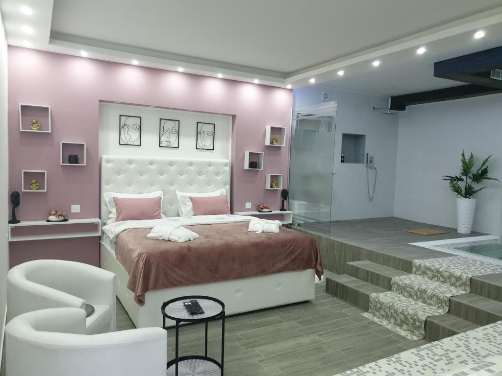 a bedroom with a bed and a walk in shower at Apartmani i sobe Gromilovic SPA in Sombor