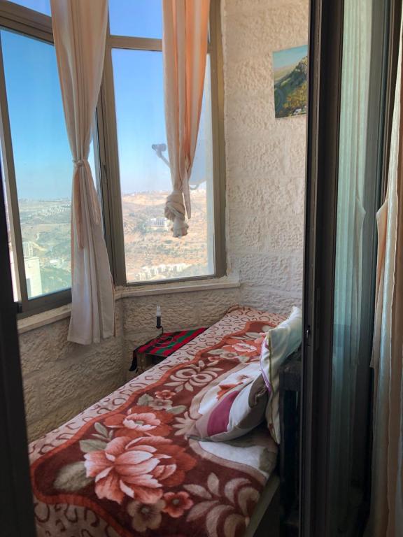 a bedroom with a bed in front of a window at King castle in Ramallah