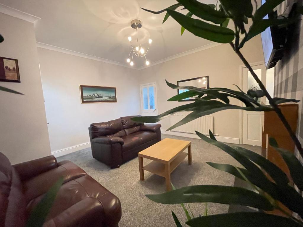 a living room with a couch and a table at The First Rho in Bishop Auckland