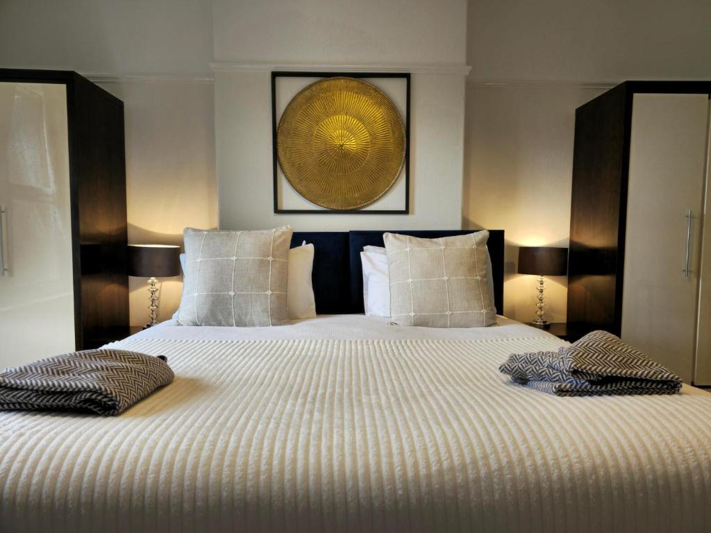 a bedroom with a large bed with two pillows at Harbour View Apartment in Llandrillo-yn-Rhôs