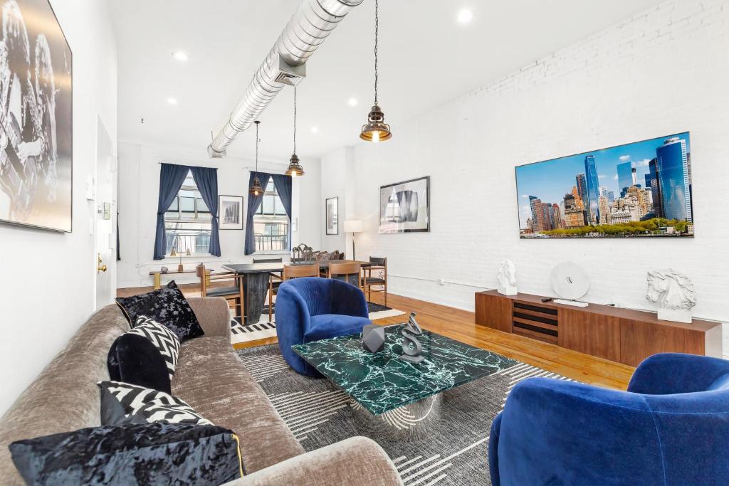 a living room with blue chairs and a couch at Luxurious 3 BR SOHO in New York