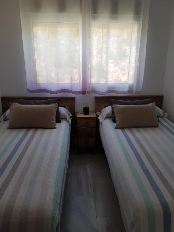Postel nebo postele na pokoji v ubytování HR PARADISE CALA DE LA VILA JOIOSA