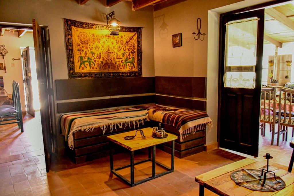 a room with a bed and a table in it at Cabaña La Rinconada Cayara in Potosí