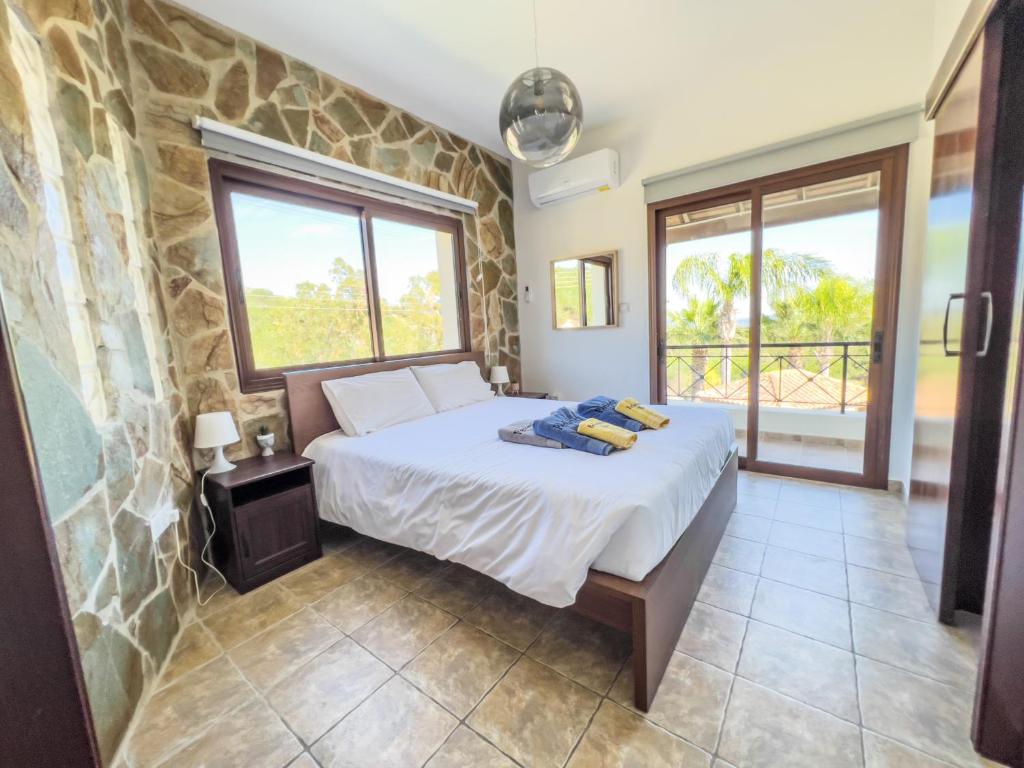 a bedroom with a bed and a stone wall at Leo's Paradise in Protaras