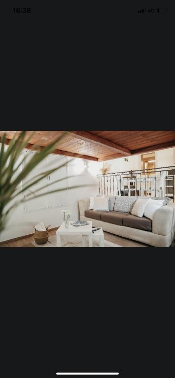 a living room with two couches and a table at La casetta di carmé in Naples